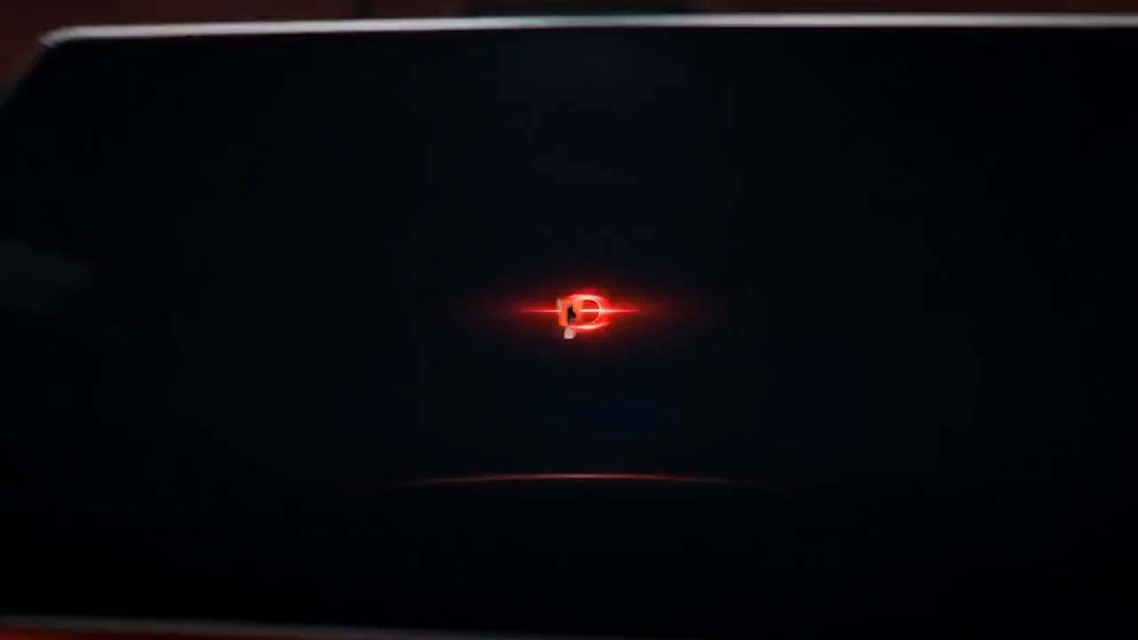 Dark automotive body panel with a centered glowing red emblem